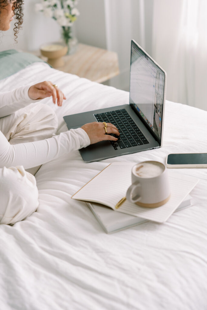 A woman types on her computer using the best task management software