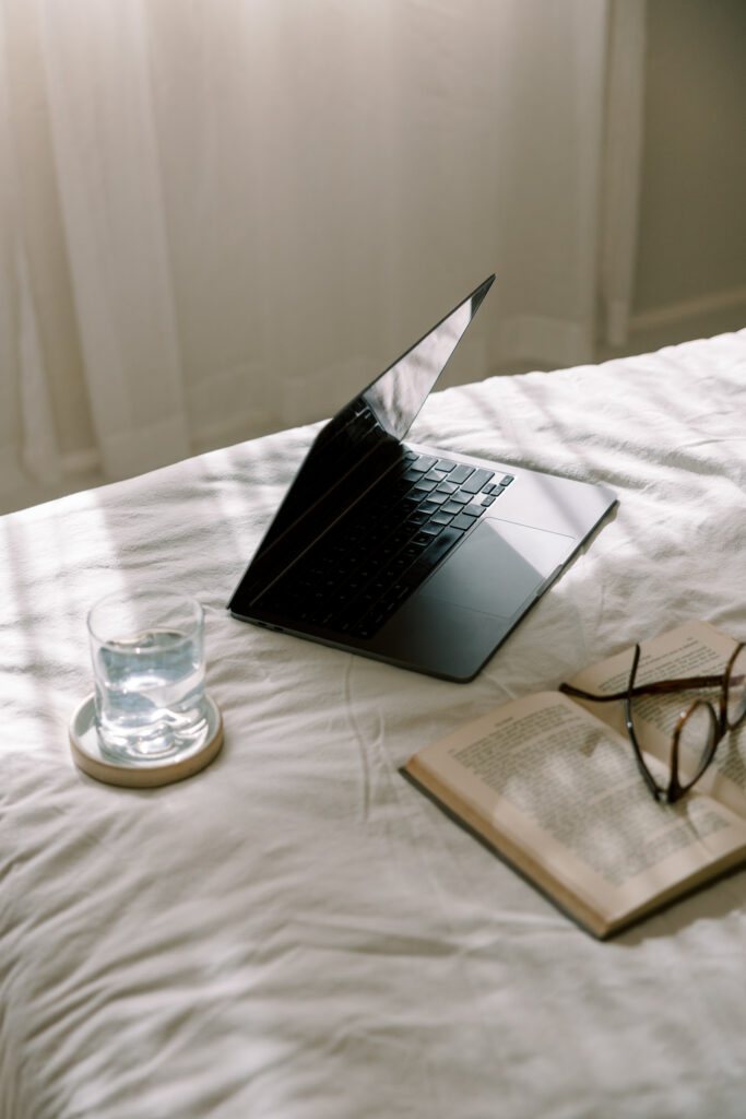 Fractional COO leaves her computer on the bed using the best task management software