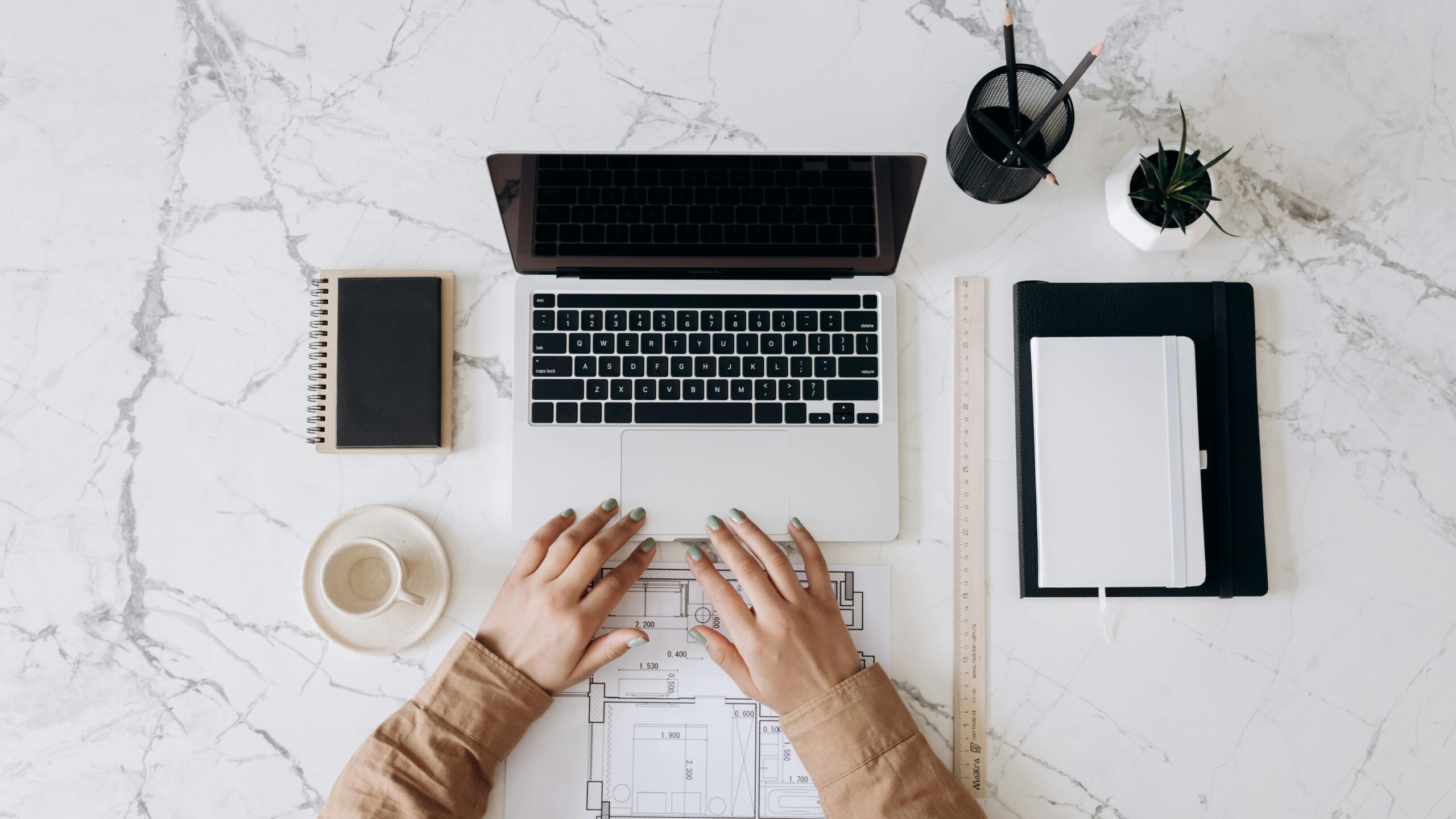 Woman types on a laptop deciding the best project management tool, ClickUp vs Asana